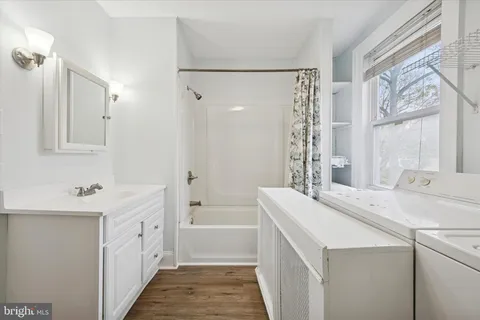 a room with a sink a vanity and a mirror