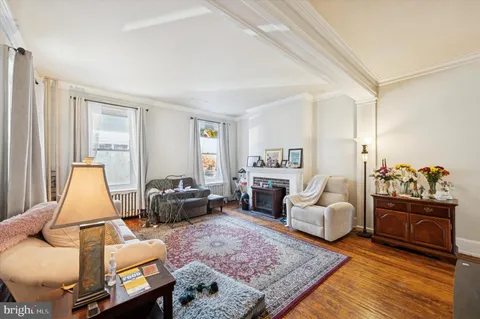 a living room with furniture fireplace and a table