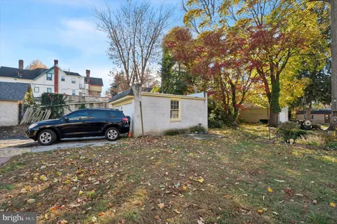a view of backyard with parked car