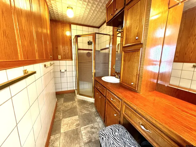 a bathroom with a double vanity sink and a large mirror