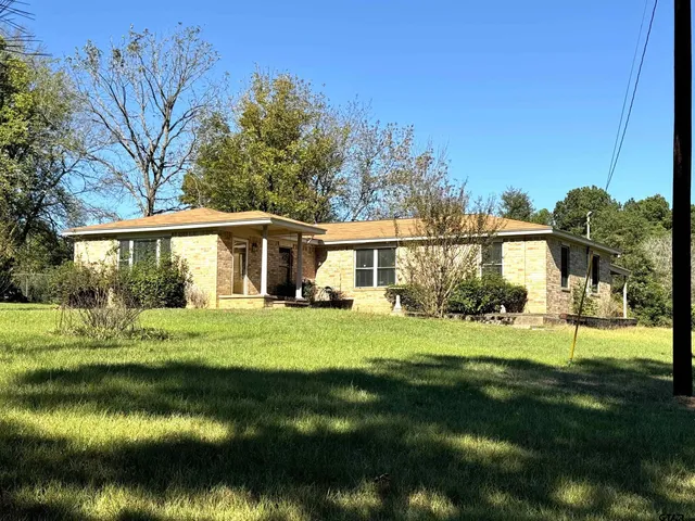 a front view of a house with a yard table and chairs