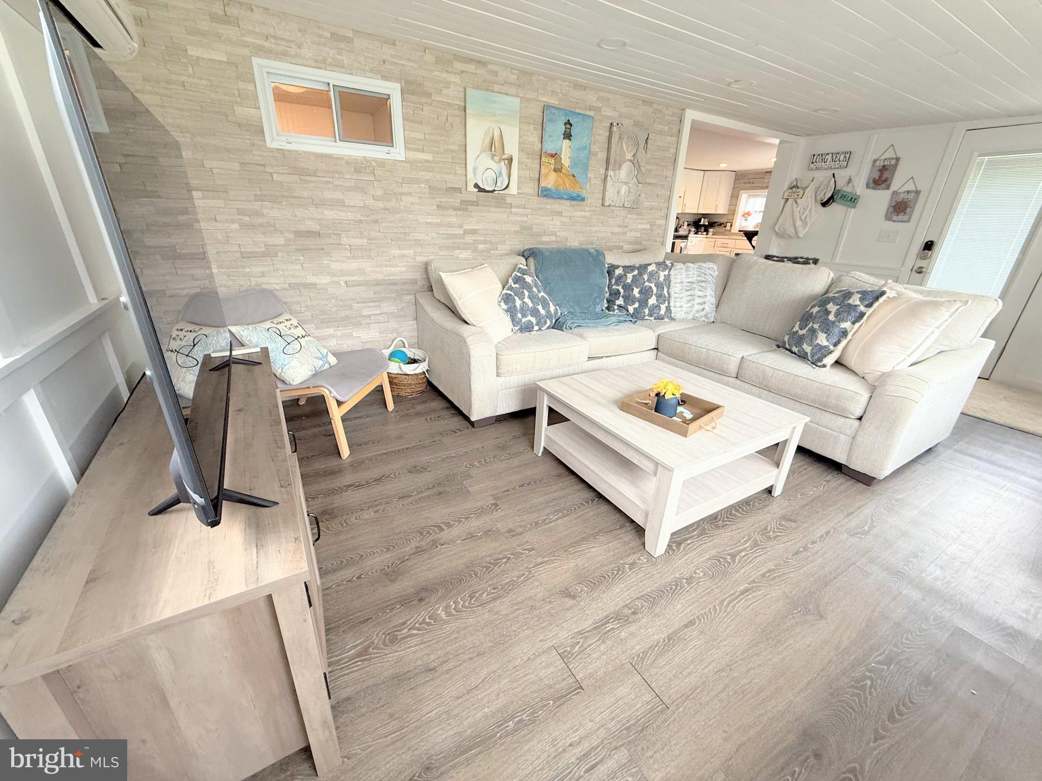 34635 Deck Street, Unit E323 Long Neck, DE 19966 - Photo 14 of 44 a living room with furniture and a rug