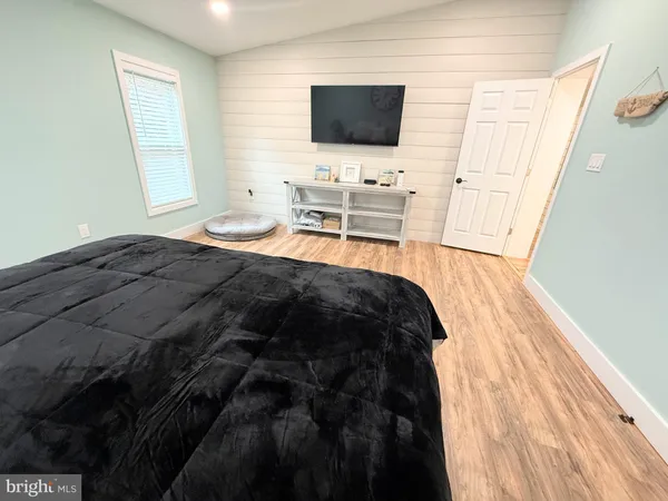 a bedroom with a bed and flat screen tv