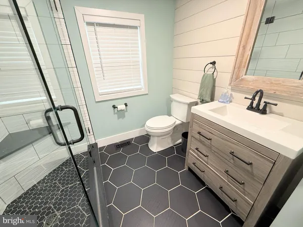 a bathroom with a sink toilet and mirror