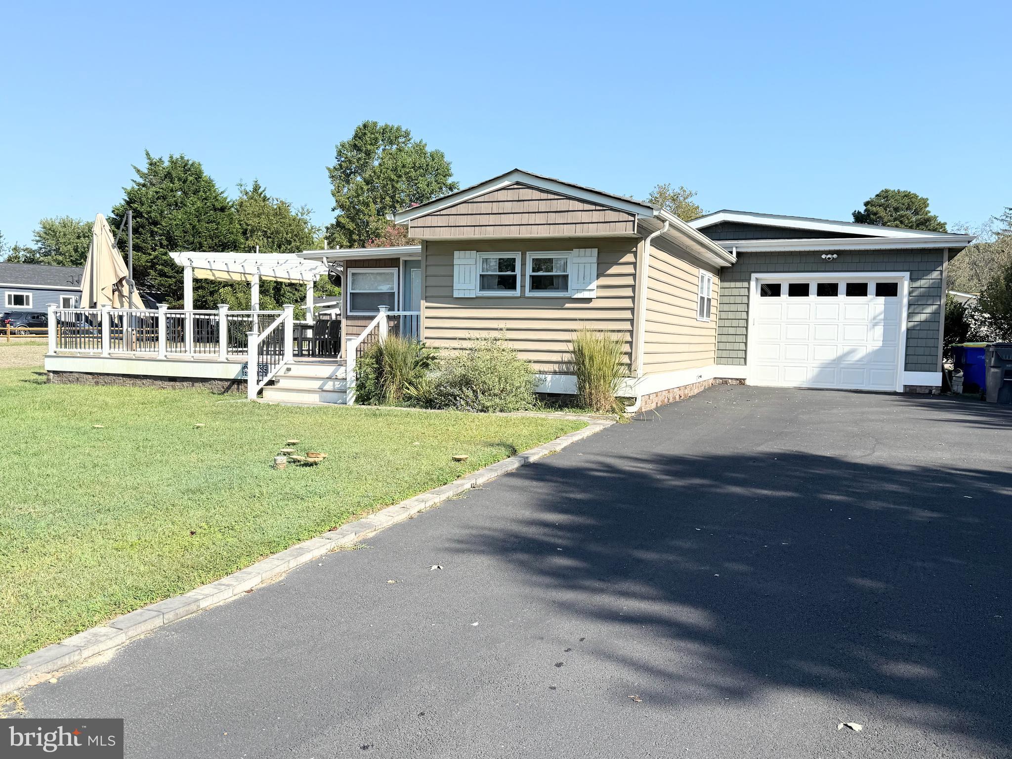34635 Deck Street, Unit E323 Long Neck, DE 19966 - Photo 3 of 44 a front view of a house with garden