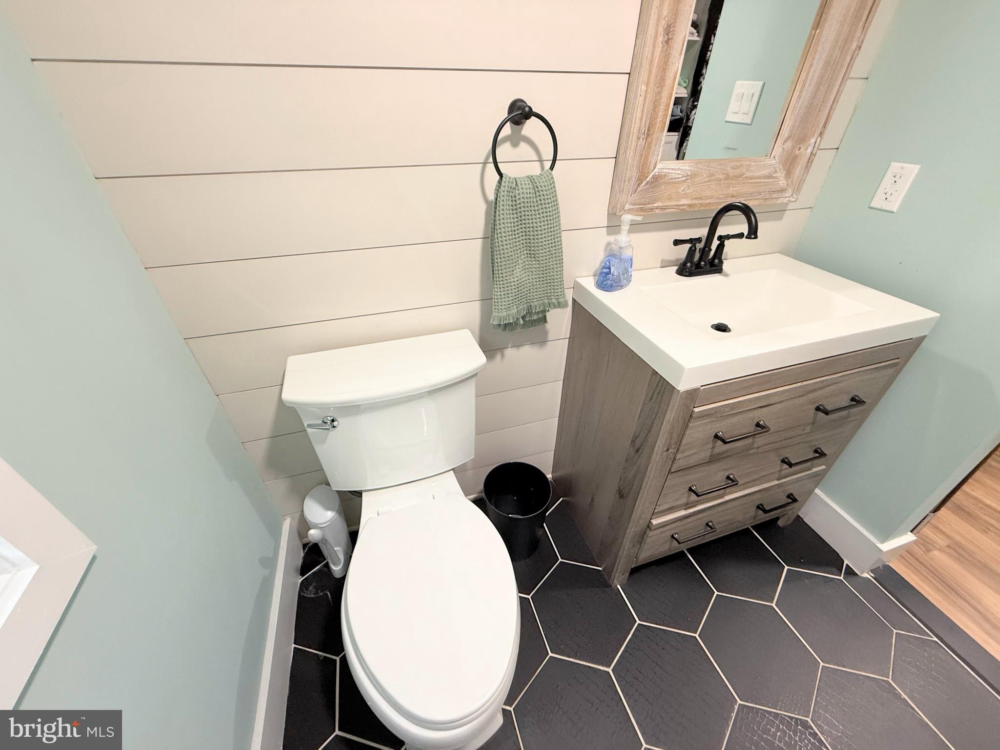 34635 Deck Street, Unit E323 Long Neck, DE 19966 - Photo 31 of 44 a bathroom with a toilet and a sink