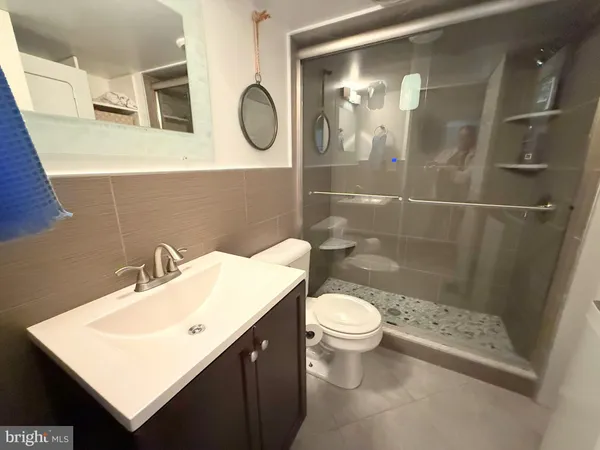 a bathroom with a sink a toilet and a mirror