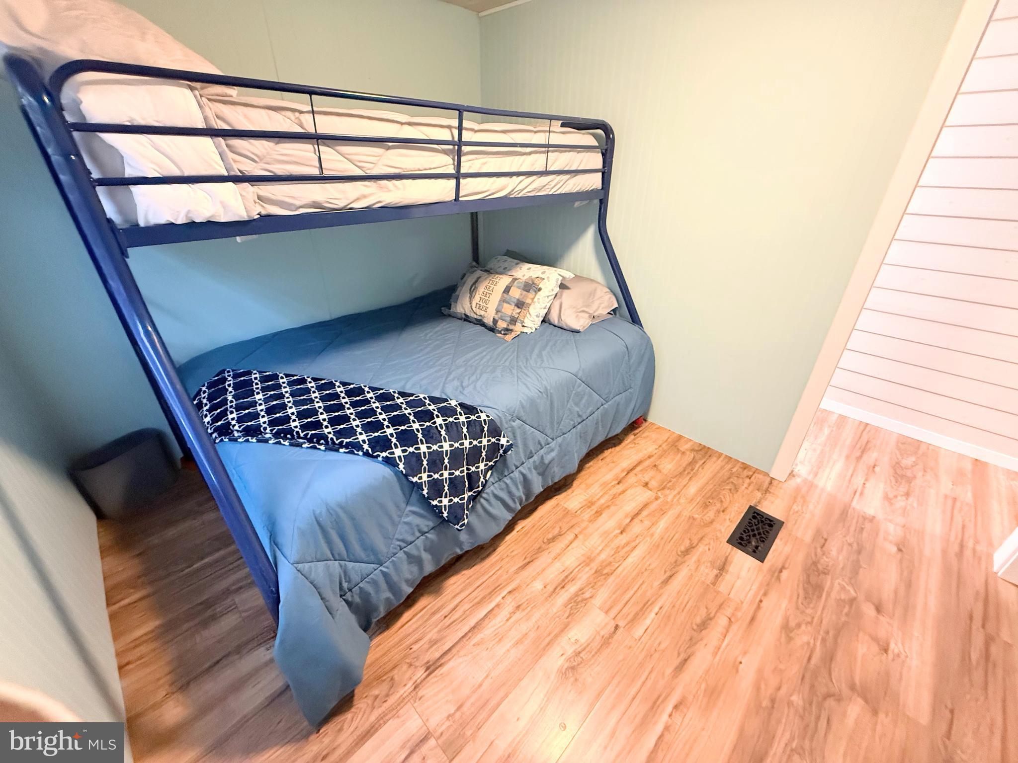 34635 Deck Street, Unit E323 Long Neck, DE 19966 - Photo 39 of 44 a bedroom with a bed and a window