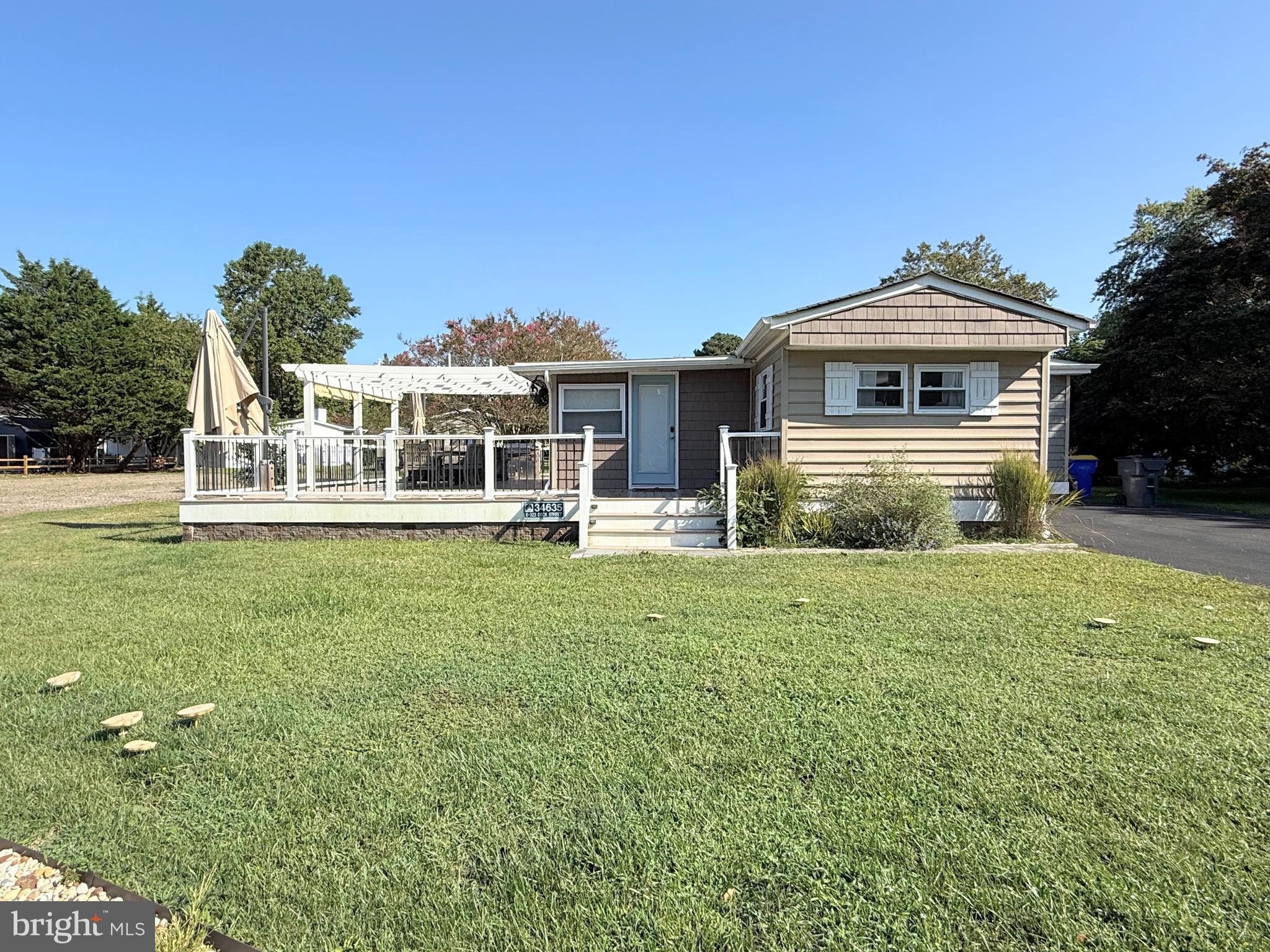 34635 Deck Street, Unit E323 Long Neck, DE 19966 - Photo 4 of 44 a front view of a house with a garden