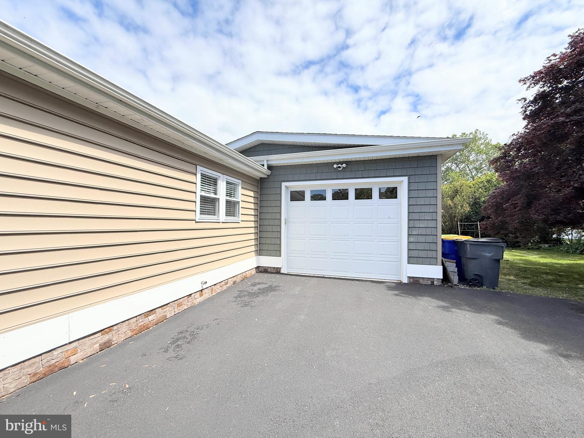 34635 Deck Street, Unit E323 Long Neck, DE 19966 - Photo 43 of 44 a view of a house with a barbeque and large trees