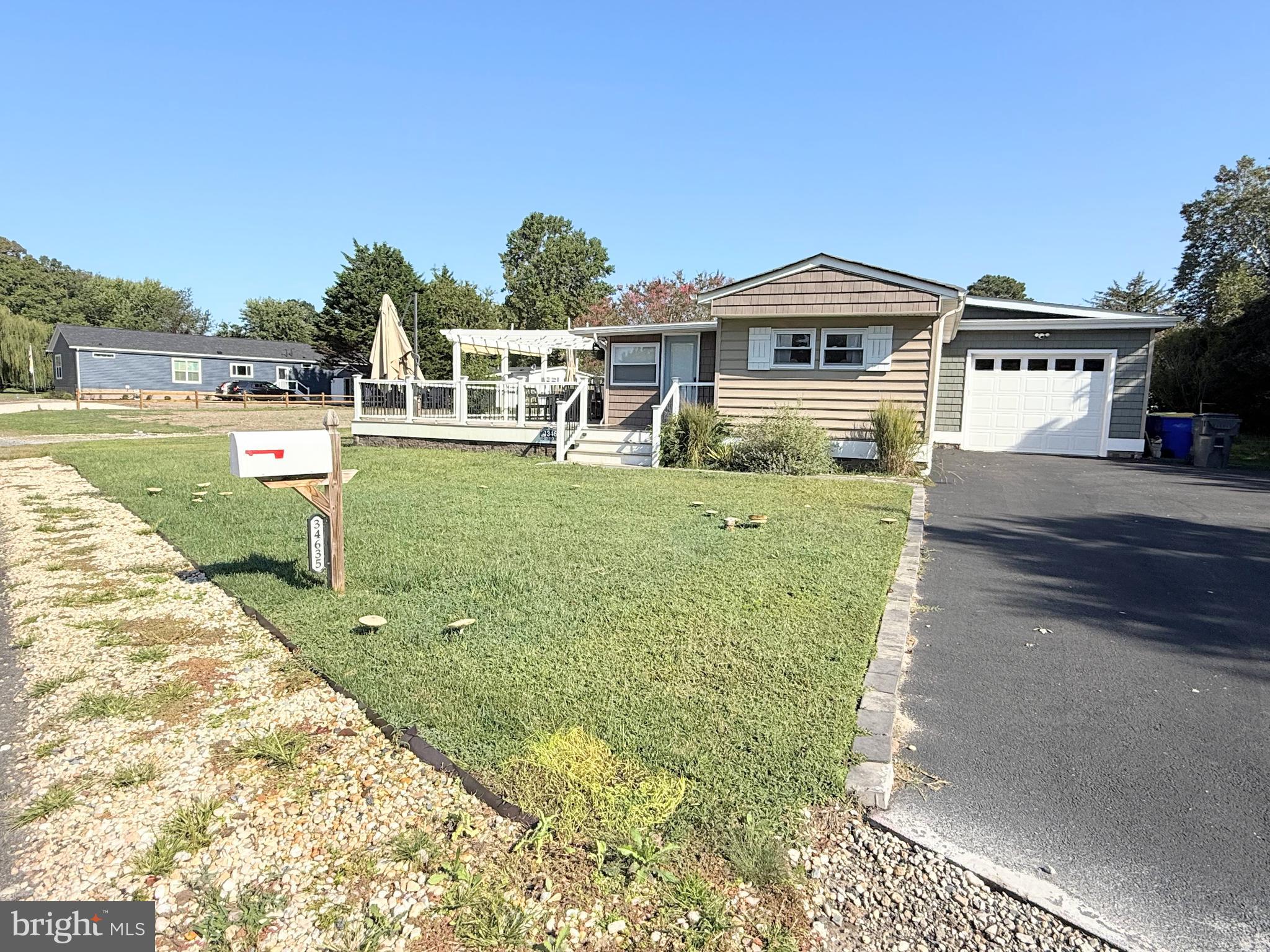 34635 Deck Street, Unit E323 Long Neck, DE 19966 - Photo 6 of 44 a front view of a house with garden