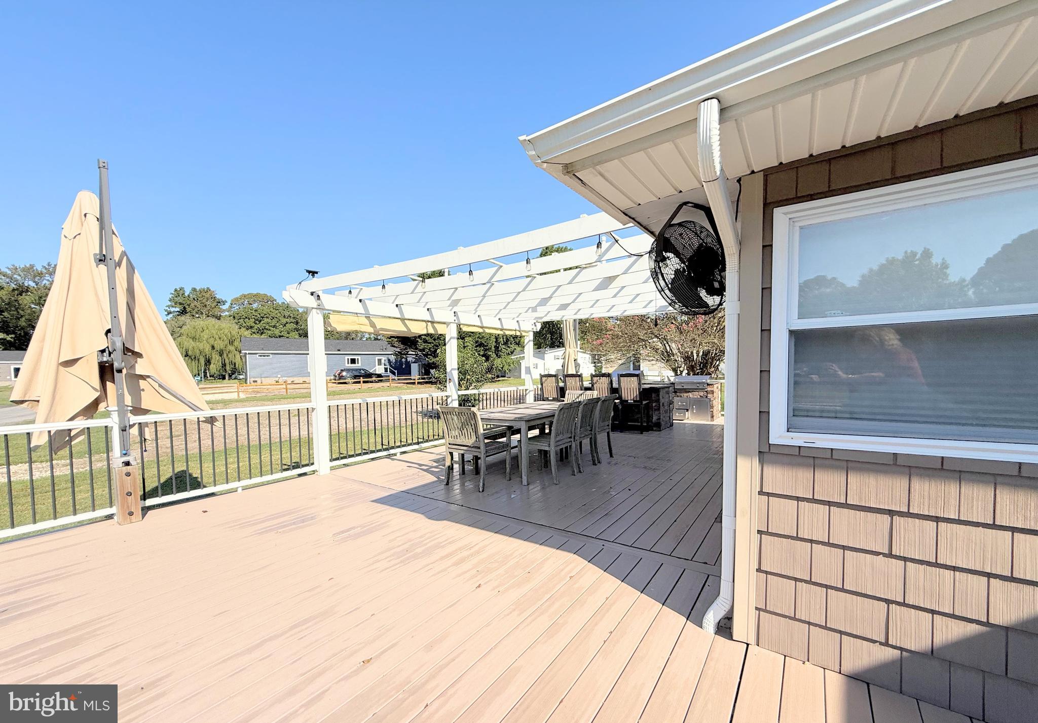 34635 Deck Street, Unit E323 Long Neck, DE 19966 - Photo 8 of 44 a view of a patio with a table and chairs