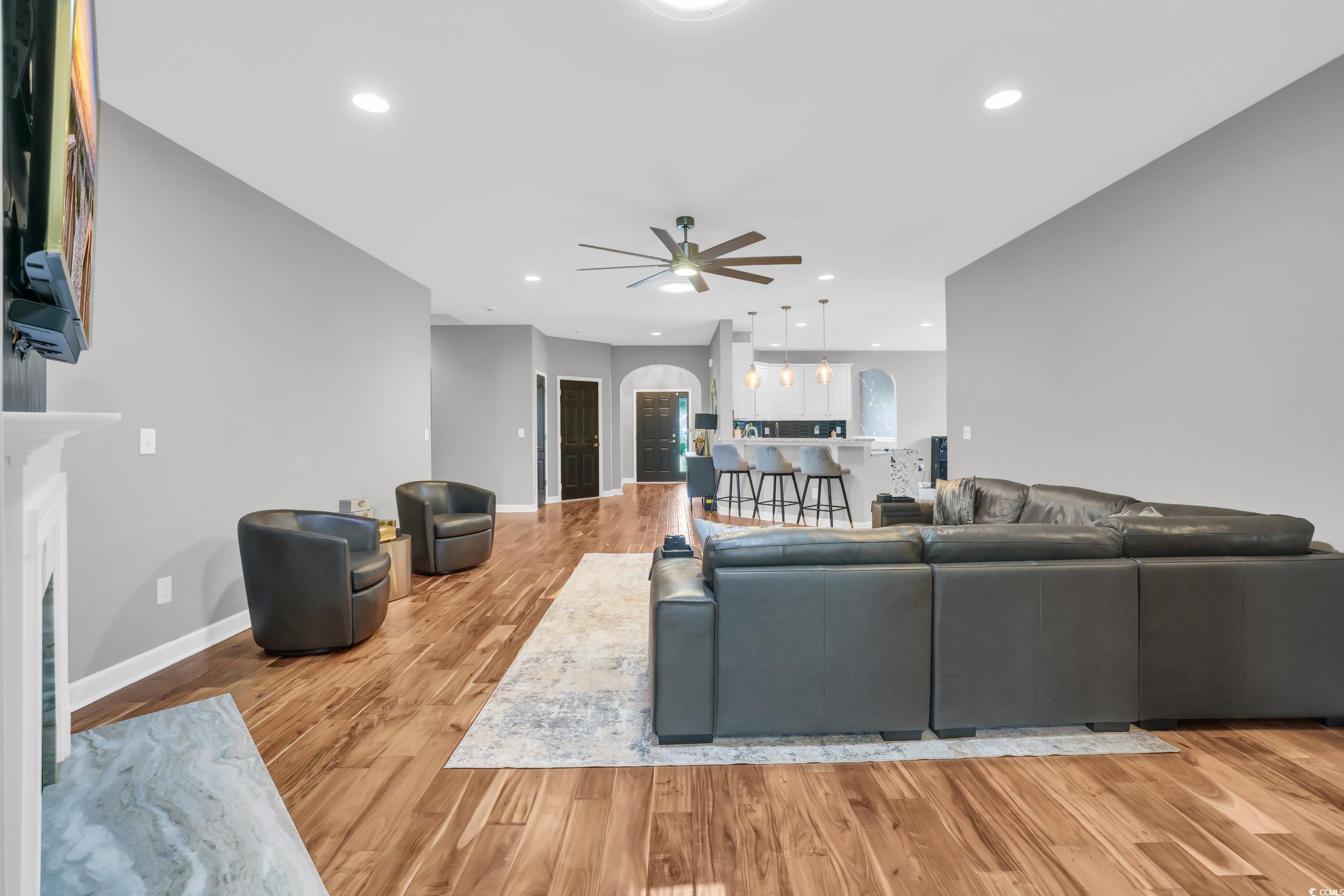 1705 Brookshade Court Conway, SC 29526 - Photo 15 of 40 Living area with light wood finished floors, arched walkways, a fireplace, recessed lighting, and ceiling fan