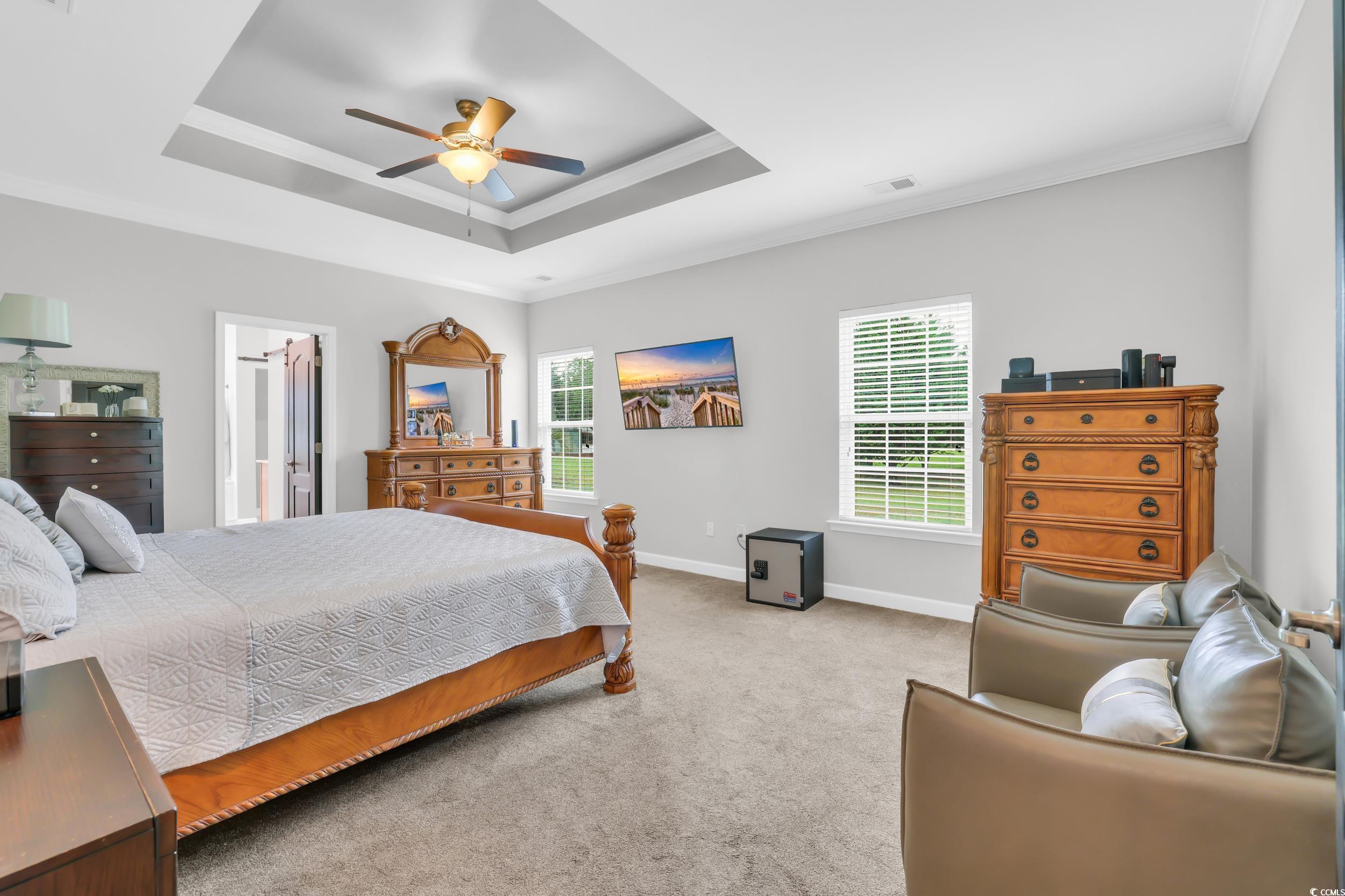 1705 Brookshade Court Conway, SC 29526 - Photo 18 of 40 Bedroom with crown molding, a raised ceiling, light carpet, and ceiling fan