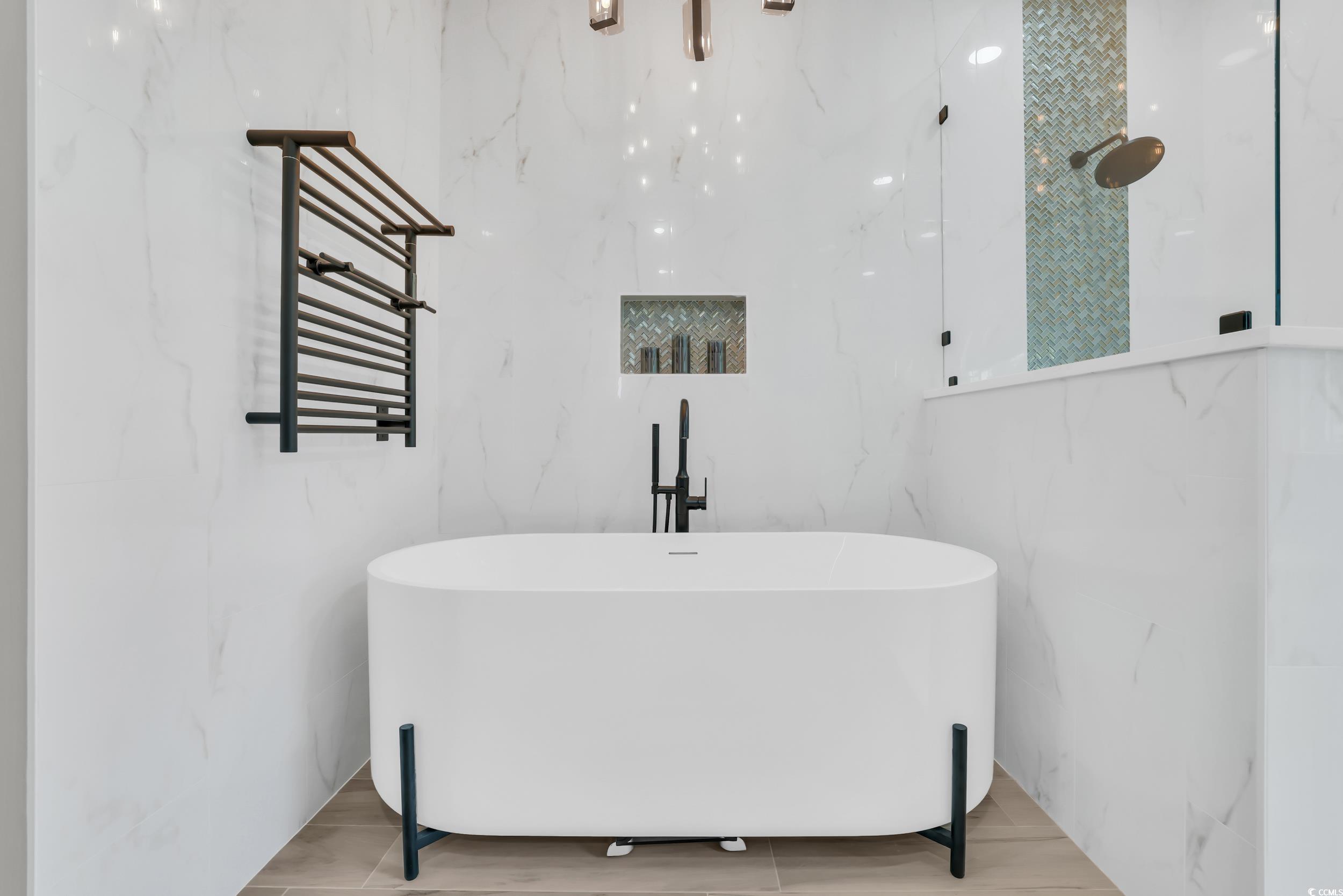 1705 Brookshade Court Conway, SC 29526 - Photo 20 of 40 Full bath with a soaking tub, a towel warmer, radiator, and wood finished floors