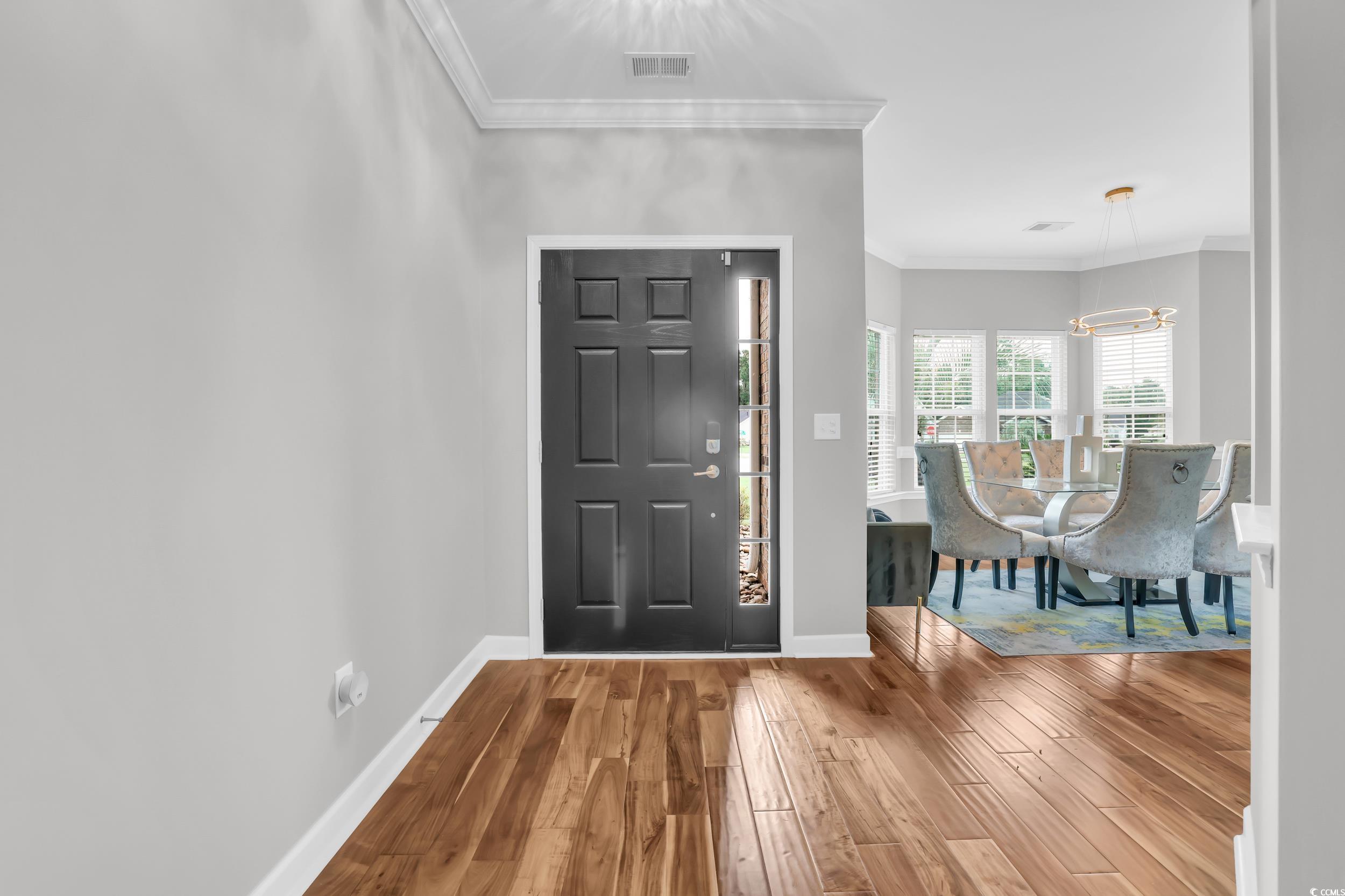 1705 Brookshade Court Conway, SC 29526 - Photo 3 of 40 Foyer with ornamental molding, a chandelier, and wood finished floors