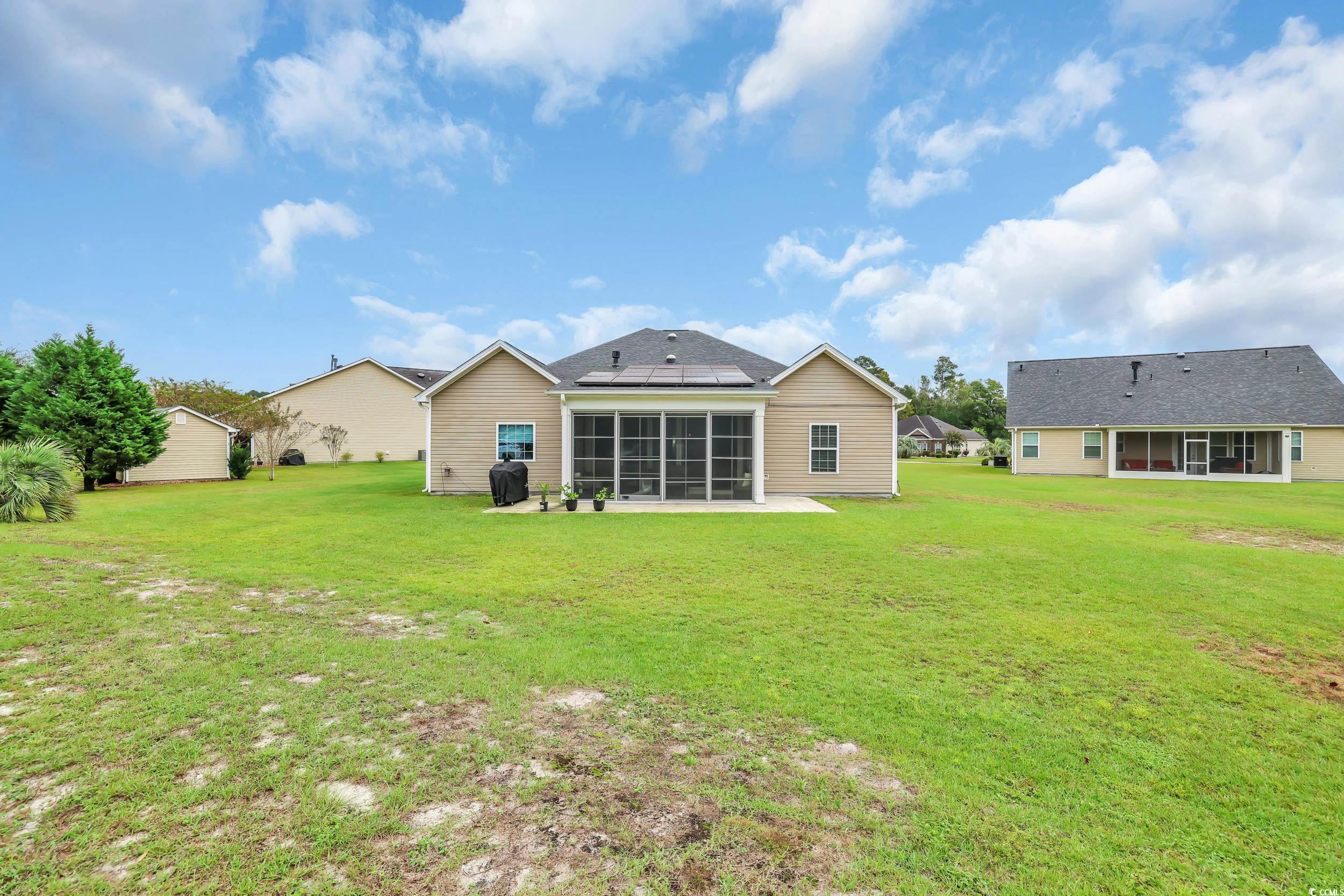 1705 Brookshade Court Conway, SC 29526 - Photo 34 of 40 Rear view of property featuring a lawn, a sunroom, and a patio area
