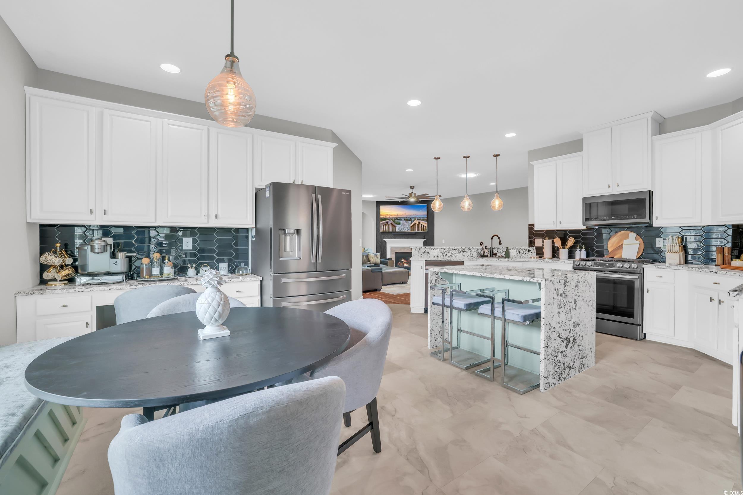 1705 Brookshade Court Conway, SC 29526 - Photo 6 of 40 Kitchen featuring tasteful backsplash, pendant lighting, white cabinets, and recessed lighting