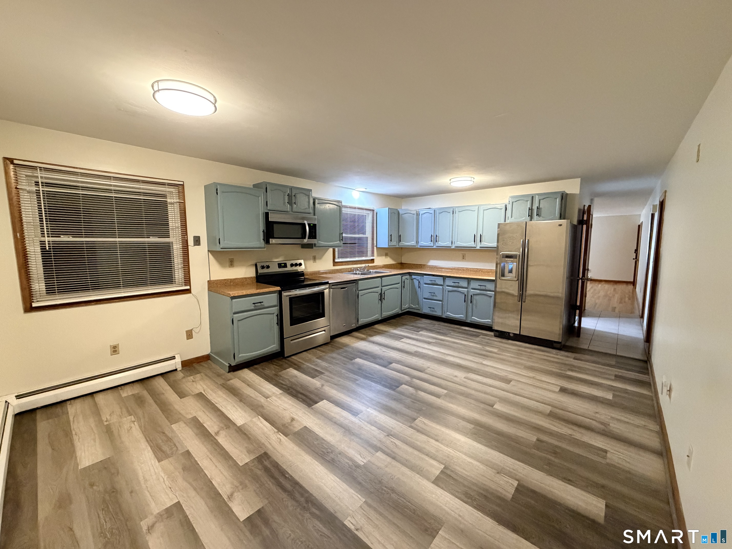 12 Hilltop Avenue, Unit 1 Waterbury, CT 06708 - Photo 2 of 7 a large kitchen with stainless steel appliances granite countertop a stove and a refrigerator