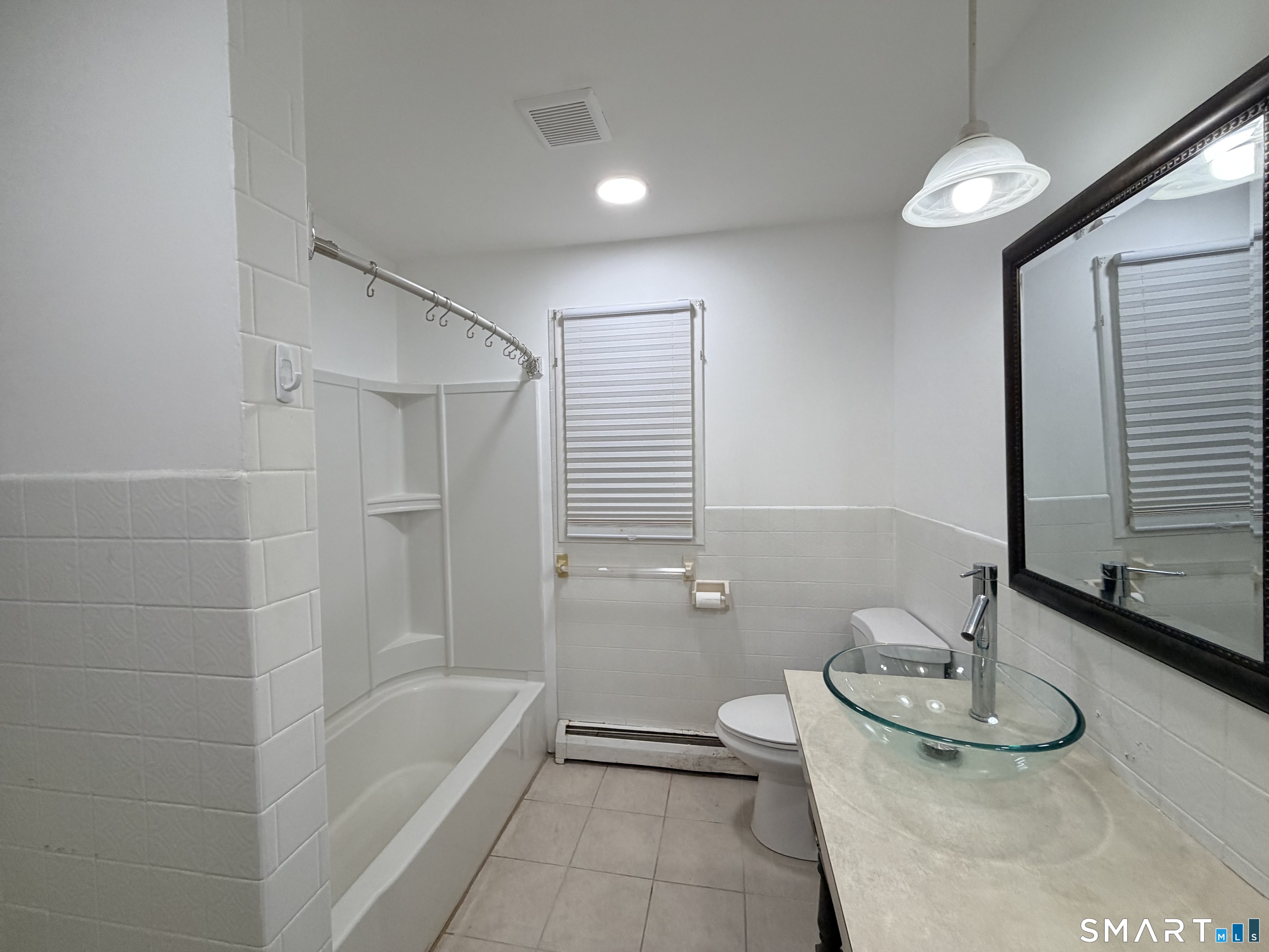 12 Hilltop Avenue, Unit 1 Waterbury, CT 06708 - Photo 4 of 7 a bathroom with a sink a toilet and tub