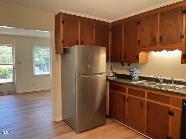 a kitchen with a refrigerator and a sink