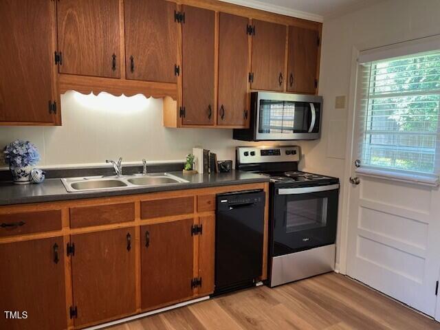 168 West Braxton Foushee Street, Unit 6 Carrboro, NC 27510 - Photo 7 of 14 a kitchen with stainless steel appliances granite countertop a stove a sink and a microwave