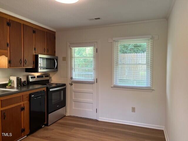 168 West Braxton Foushee Street, Unit 6 Carrboro, NC 27510 - Photo 8 of 14 a kitchen with stainless steel appliances granite countertop a stove a sink and a microwave