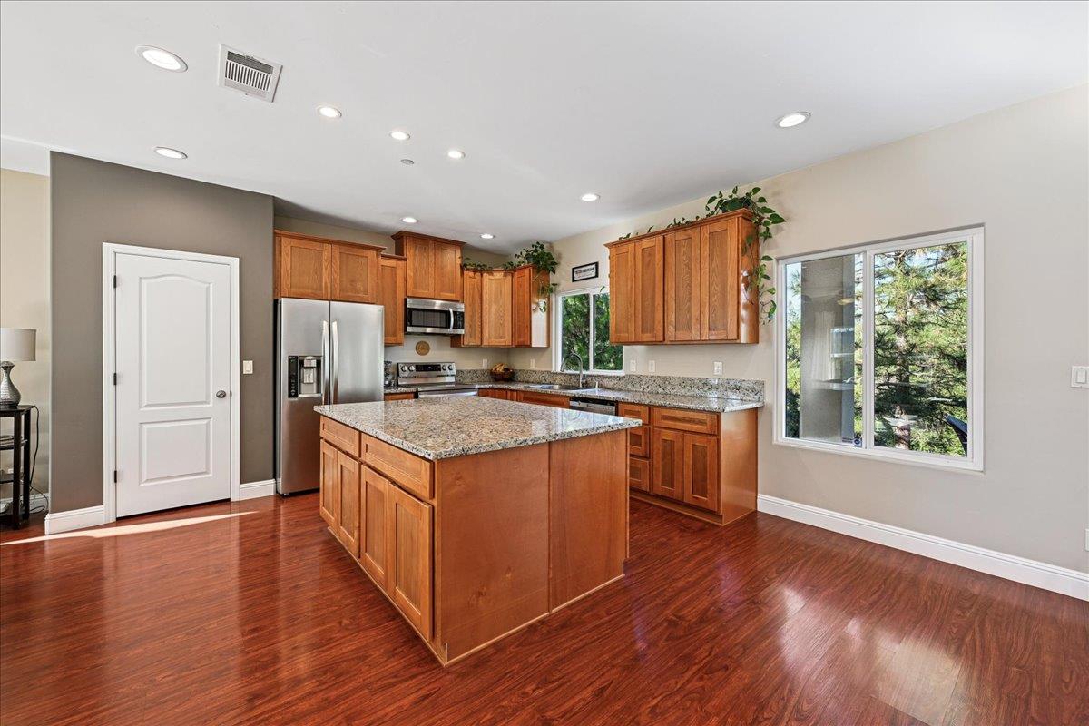 21895 One Fine Place Colfax, CA 95713 - Photo 19 of 82 a kitchen with stainless steel appliances granite countertop wooden floors and large window