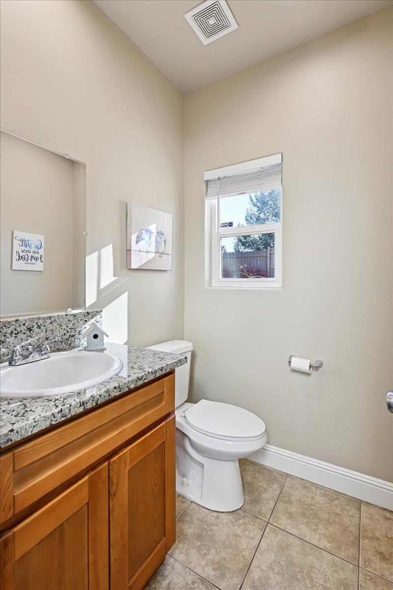 21895 One Fine Place Colfax, CA 95713 - Photo 29 of 81 a bathroom with a granite countertop sink a toilet and a mirror