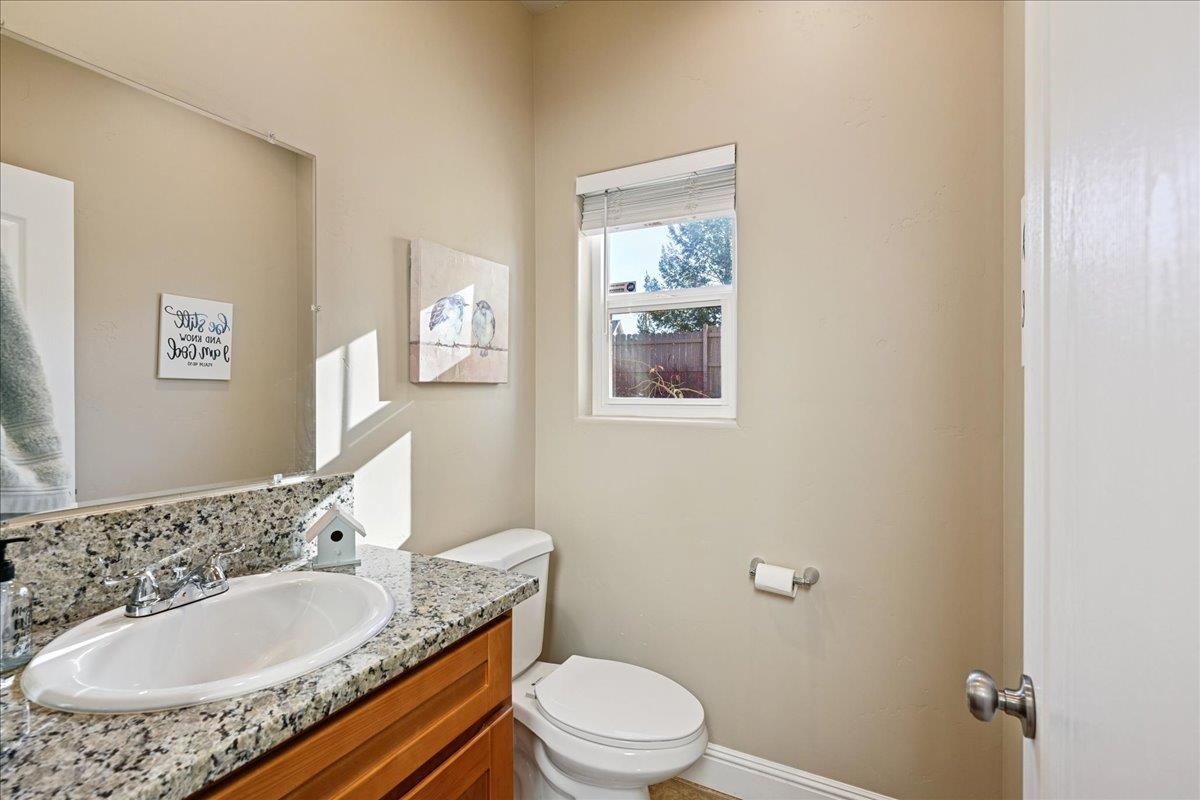 21895 One Fine Place Colfax, CA 95713 - Photo 29 of 82 a bathroom with a granite countertop sink a mirror and a toilet