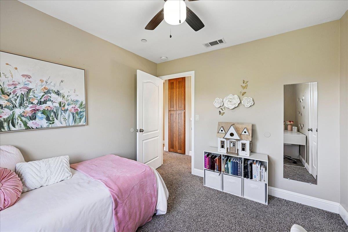 21895 One Fine Place Colfax, CA 95713 - Photo 36 of 81 a spacious bedroom with a bed and a chandelier