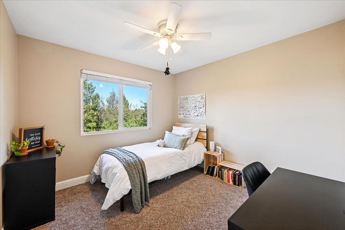 21895 One Fine Place Colfax, CA 95713 - Photo 38 of 82 a bed room with a bed and a chandelier