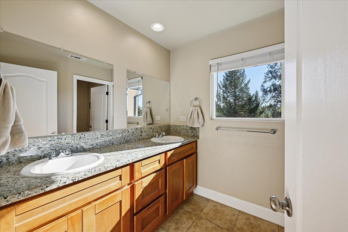 21895 One Fine Place Colfax, CA 95713 - Photo 39 of 81 a bathroom with a granite countertop sink and a mirror