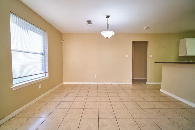 an empty room with windows and entrance