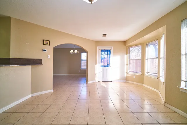 a view of a hallway with wooden floor and a living room