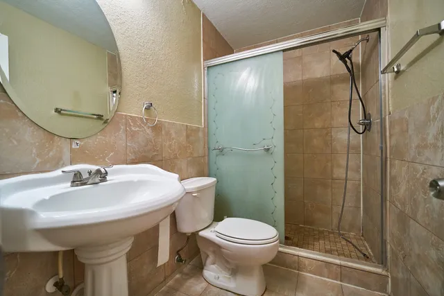 a bathroom with a sink toilet and shower