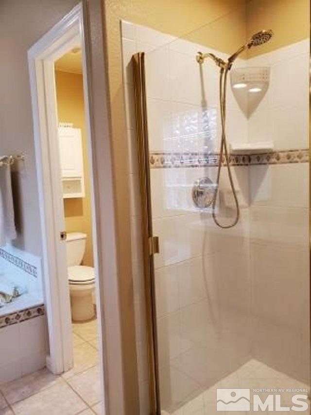 2420 Granite Springs Road Reno, NV 89519 - Photo 11 of 24 a bathroom with a granite countertop shower and a toilet