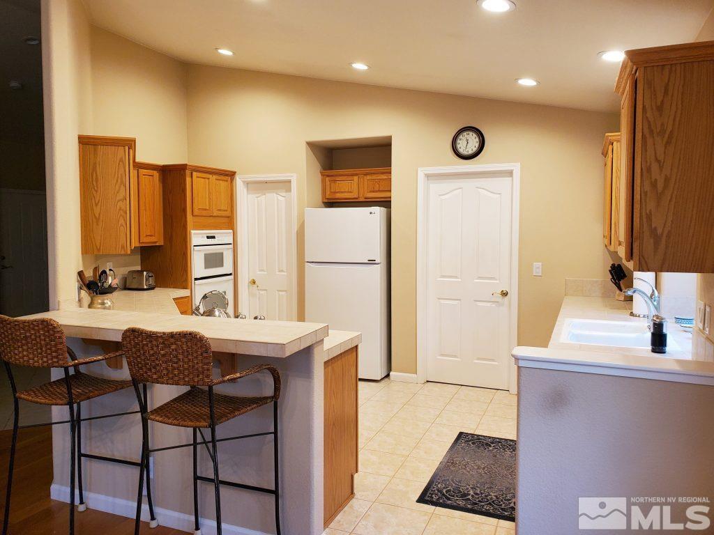 2420 Granite Springs Road Reno, NV 89519 - Photo 6 of 24 a view of a kitchen area with furniture and large window