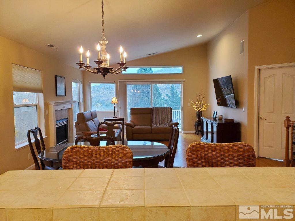 2420 Granite Springs Road Reno, NV 89519 - Photo 8 of 24 a living room with furniture a chandelier and a flat screen tv