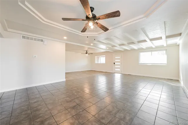 a view of a livingroom with a ceiling fan and window