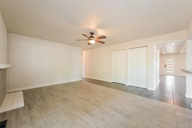 a view of a livingroom with a ceiling fan and chandelier fan