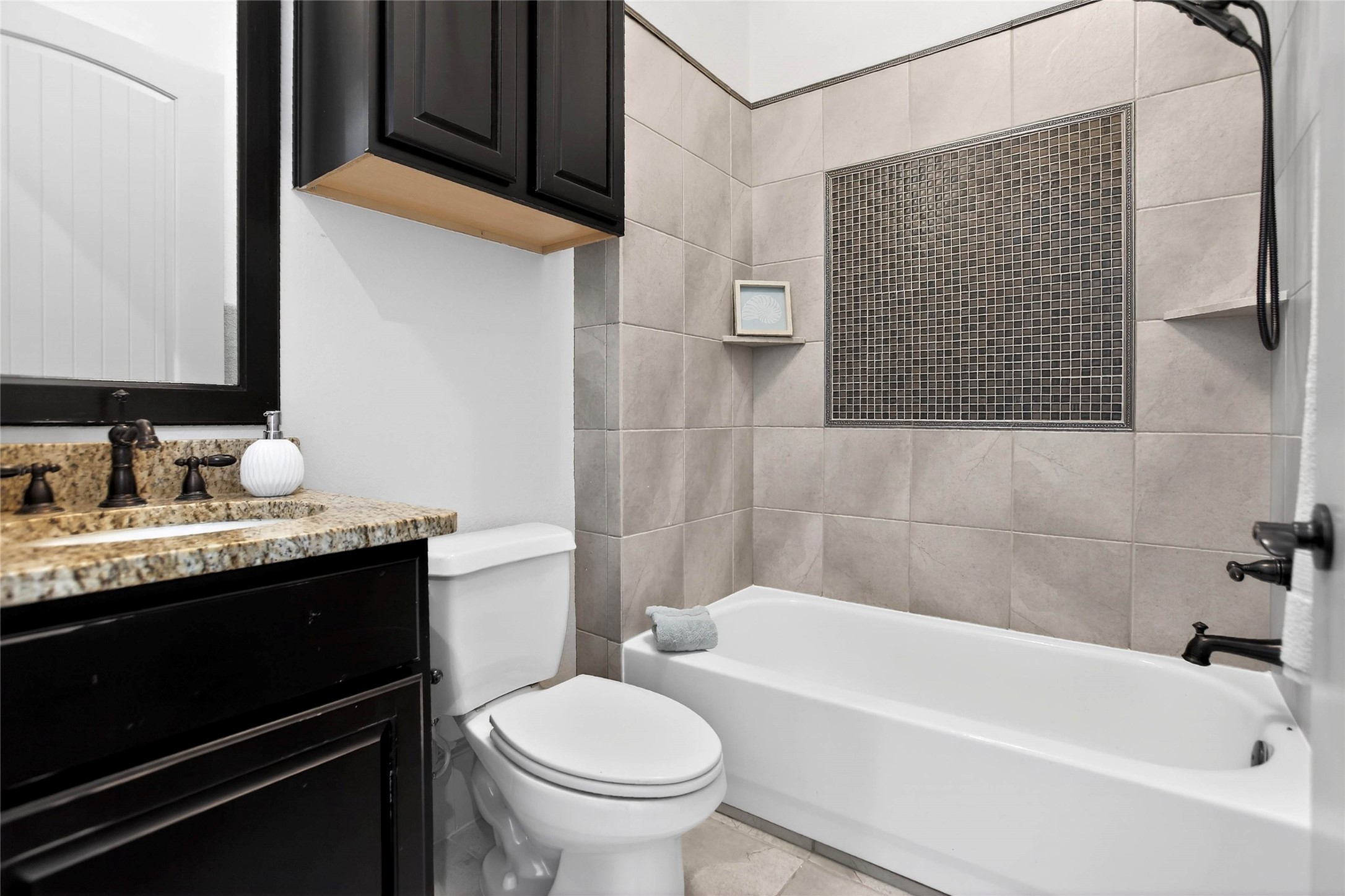 12349 Tramonto Conroe, TX 77304 - Photo 28 of 50 a bathroom with a granite countertop sink toilet and shower