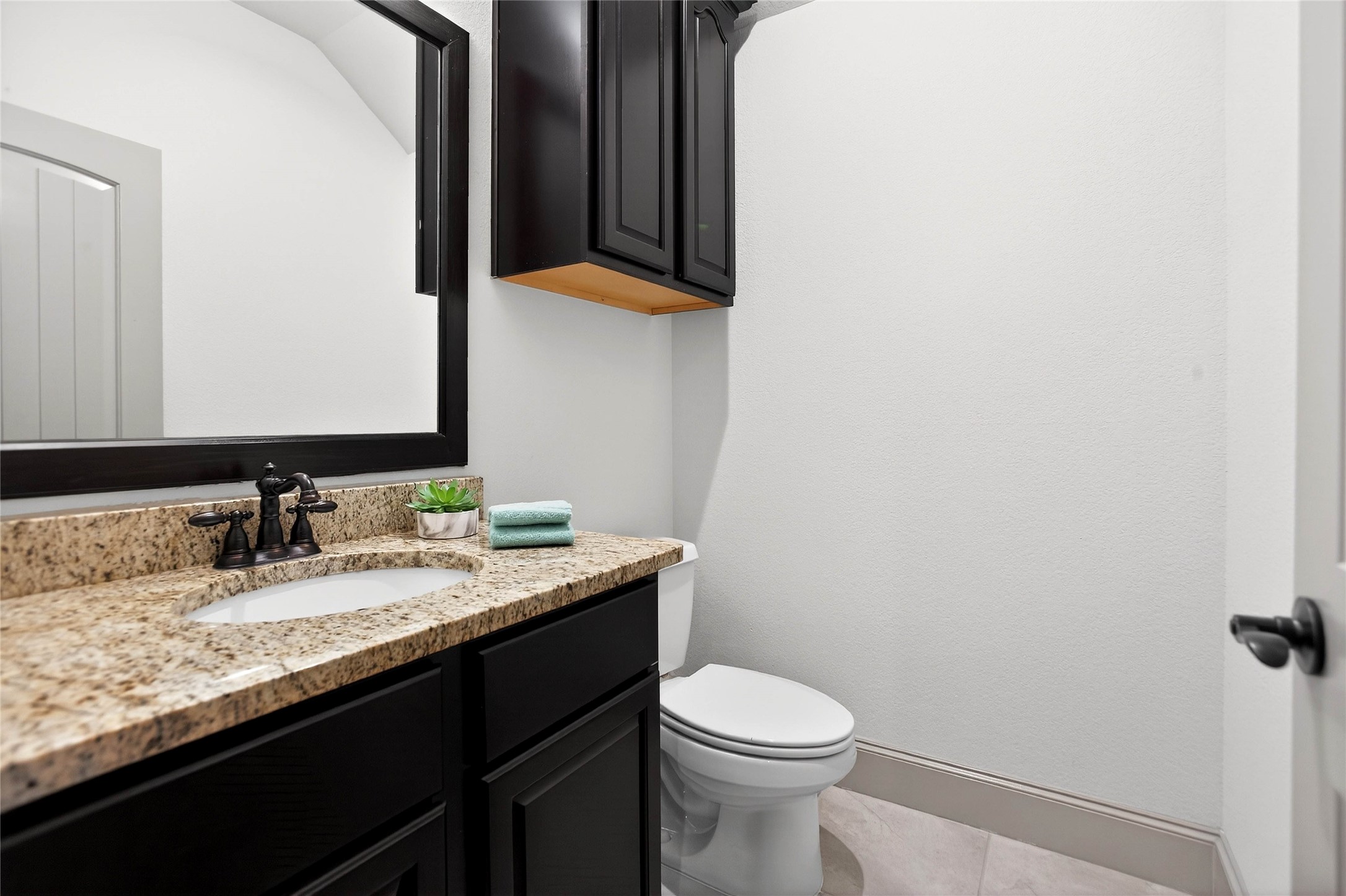 12349 Tramonto Conroe, TX 77304 - Photo 31 of 50 a bathroom with a granite countertop sink and a mirror