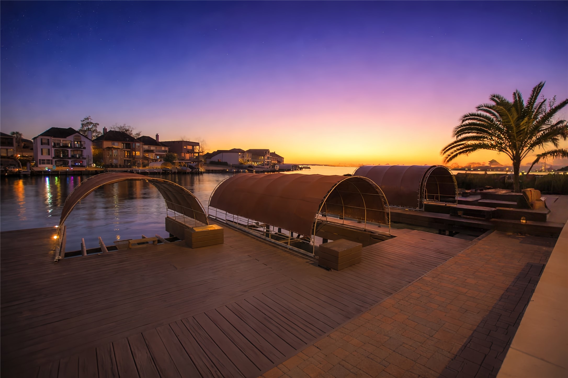 12349 Tramonto Conroe, TX 77304 - Photo 4 of 50 It comes with a spacious deck with covered boat docks, offering serene sunset views and direct access to the water, perfect for boating enthusiasts and those seeking a tranquil lifestyle.