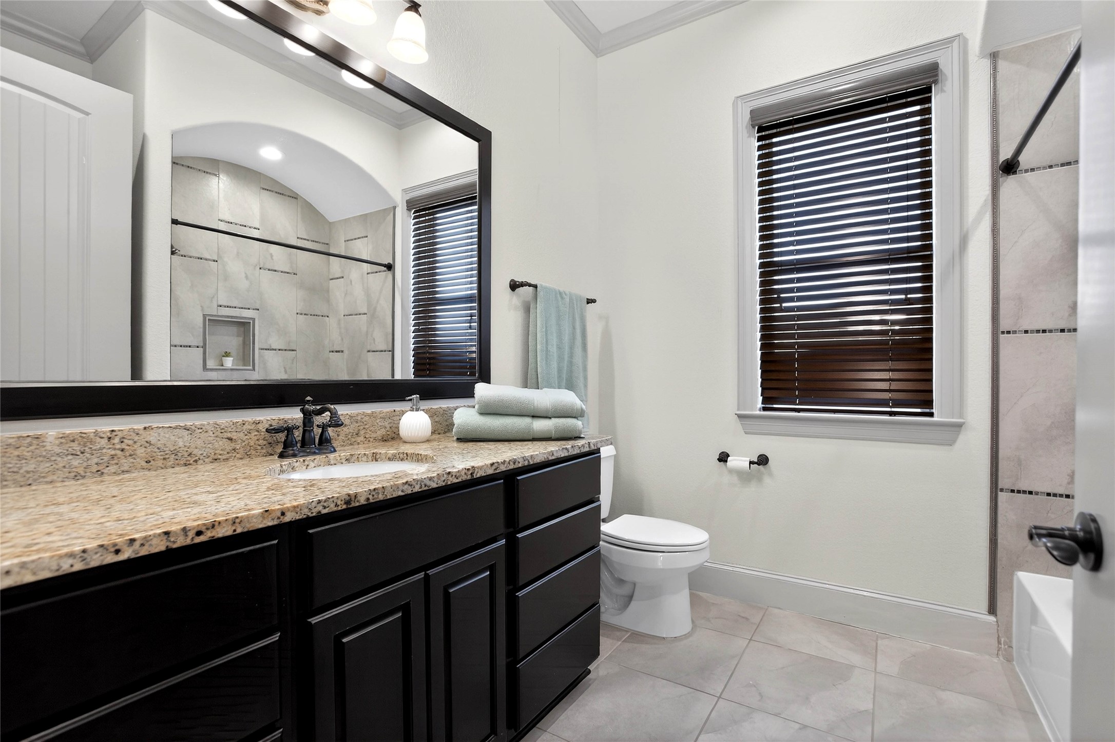 12349 Tramonto Conroe, TX 77304 - Photo 42 of 50 a bathroom with a granite countertop sink toilet and mirror