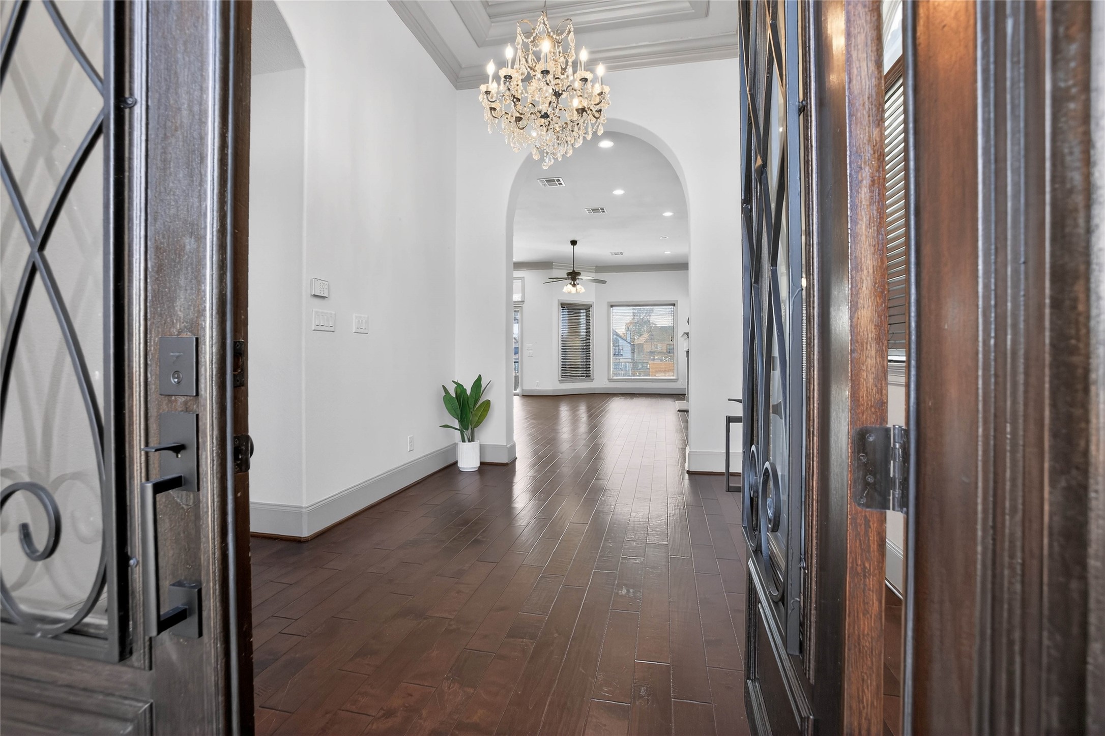 12349 Tramonto Conroe, TX 77304 - Photo 10 of 50 a view of a hallway with wooden floor and a chandelier