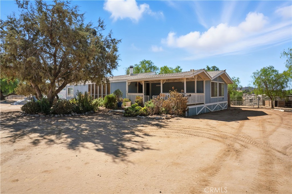 18880 Country Pine Road Perris, CA 92570 - Photo 1 of 1 a front view of a house with a yard