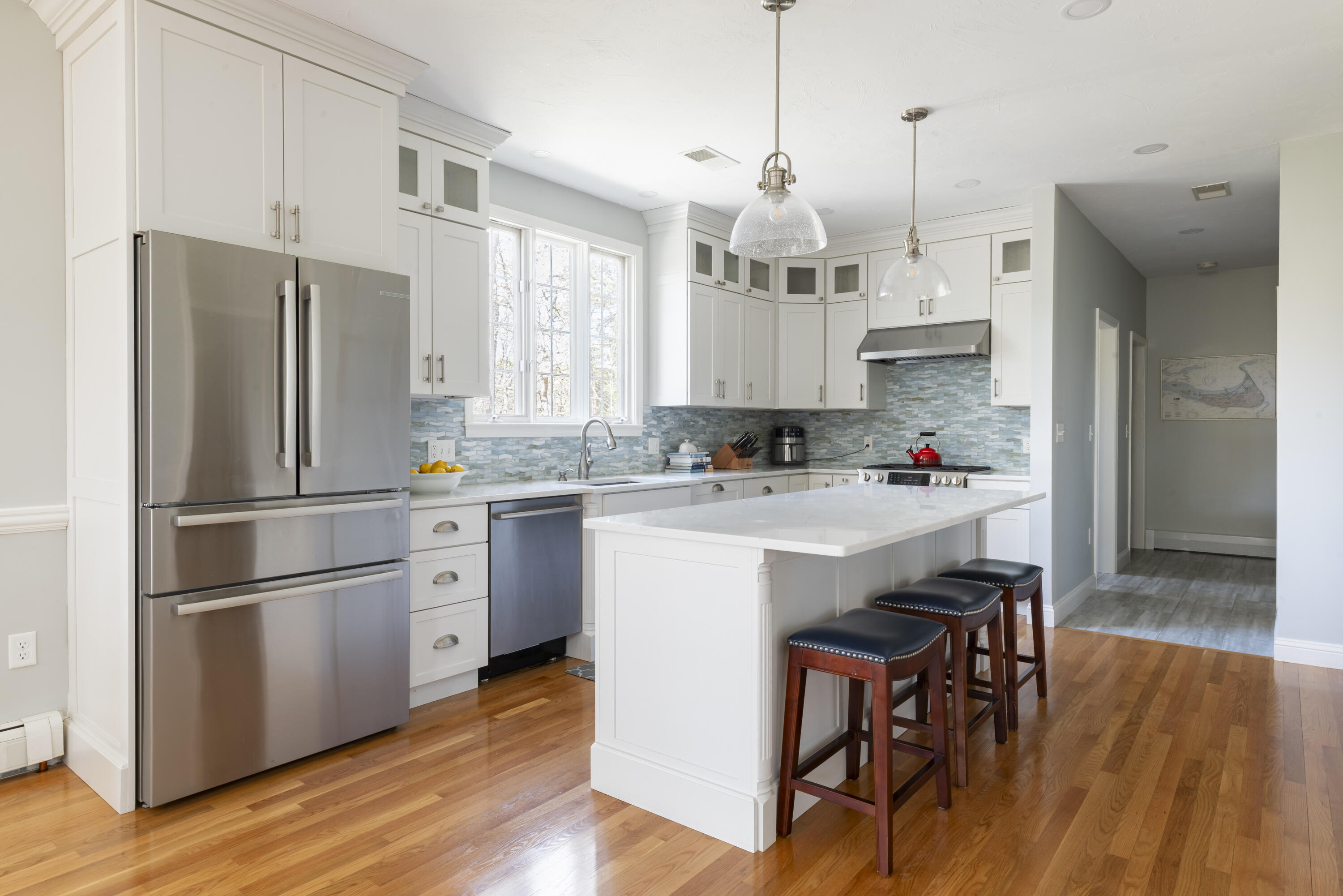331 Riverview Drive Chatham, MA 02633 - Photo 13 of 50 a kitchen with stainless steel appliances granite countertop a refrigerator a sink dishwasher a stove and white cabinets with wooden floor
