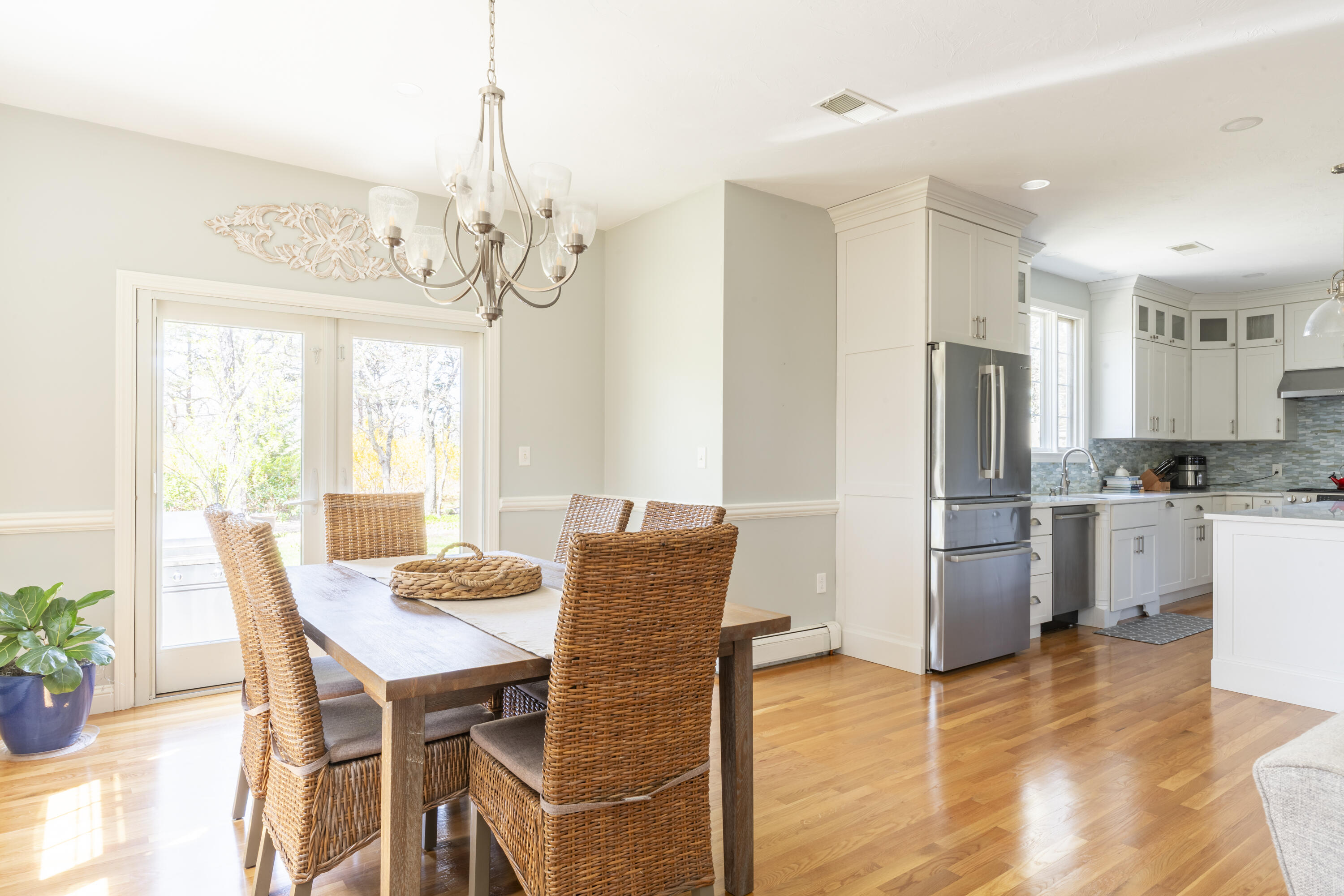 331 Riverview Drive Chatham, MA 02633 - Photo 20 of 50 a dining room with stainless steel appliances kitchen island granite countertop furniture and a chandelier