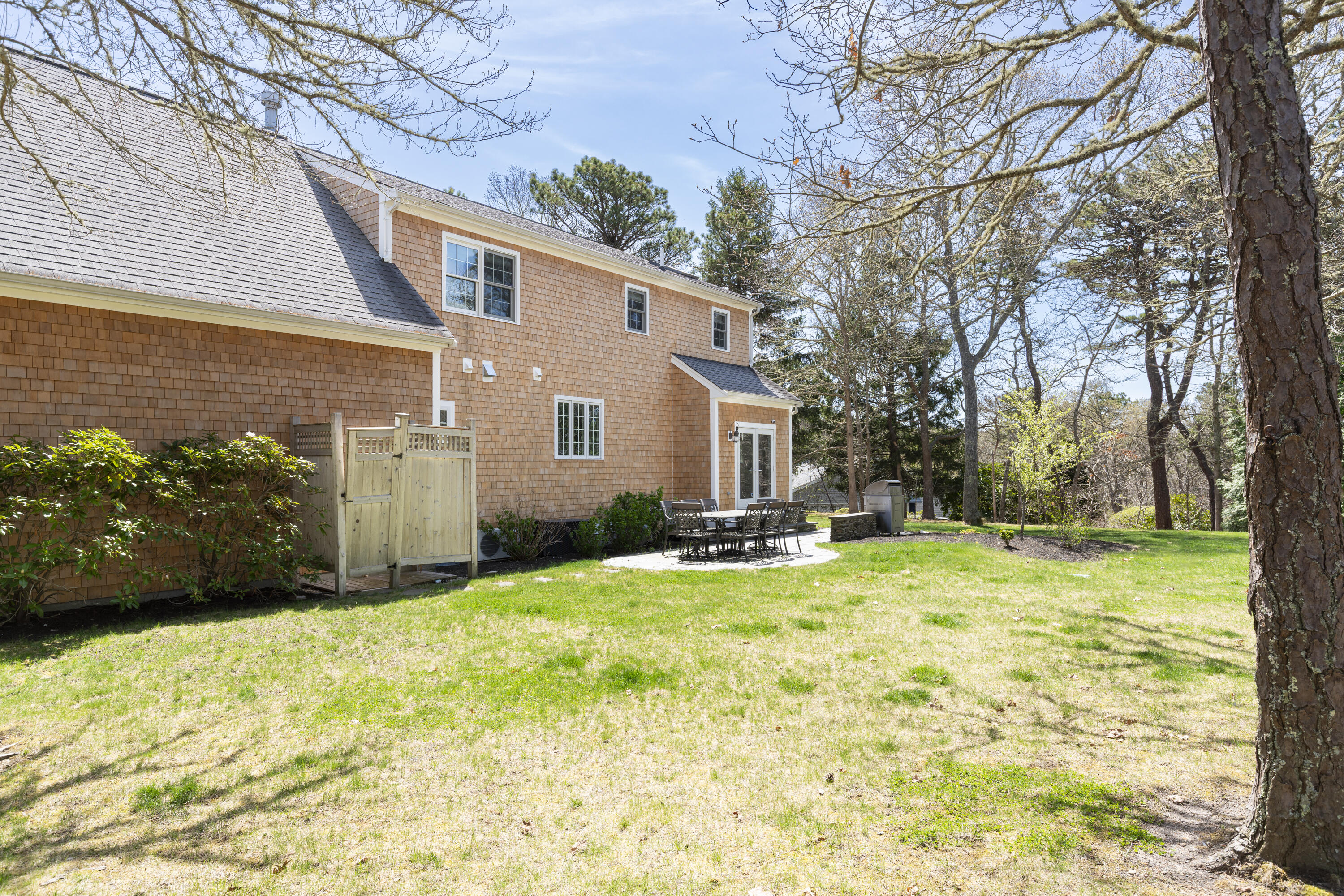 331 Riverview Drive Chatham, MA 02633 - Photo 46 of 50 a view of a backyard with plants and large tree